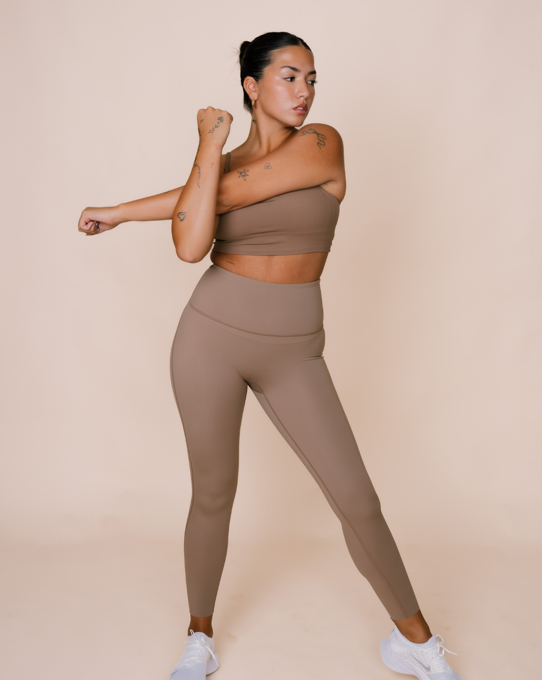 Form-fitting exercise wear in neutral color